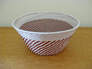 Coppery-brown and white hand-woven telephone-wire basket