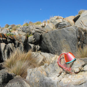 Fab-40 basket nestled in the rocks at Cape St Albans, Kangaroo Island, with the moon rising in the clear blue afternoon sky.