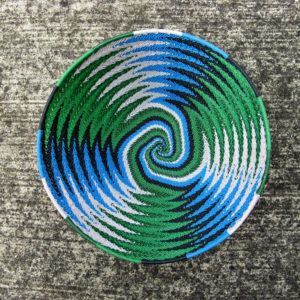 The inside of a Jane's telephone-wire basket photographed from above, showing the chevron pattern for the sides blending into a spiral colours at the base.