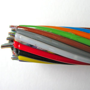 A close-up of the brightly coloured, helically arranged plastic tubes that enclose optic fibres, showing the sticky water-repellent gel.