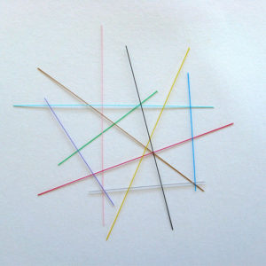 Short strands of translucent optic fibre individually coloured in purple, brown, red, pink, green, navy, light blue, black, yellow and grey.