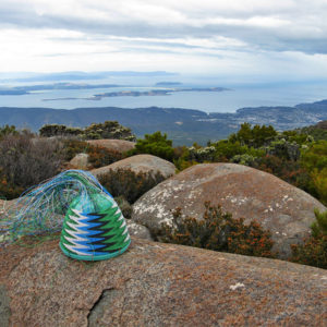 Telephone-wire basket in its mould, on rocks on Mt Wellinton, overlooking South Arm and the Derwent Estuary.