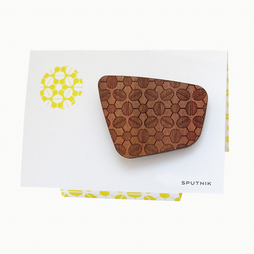 Sputnik patterned brooch in Tasmanian myrtle Brooch in Tasmanian Myrtle wood veneer, with a retro-inspired pattern derived from old-fashioned champagne glasses rotated around a bubble